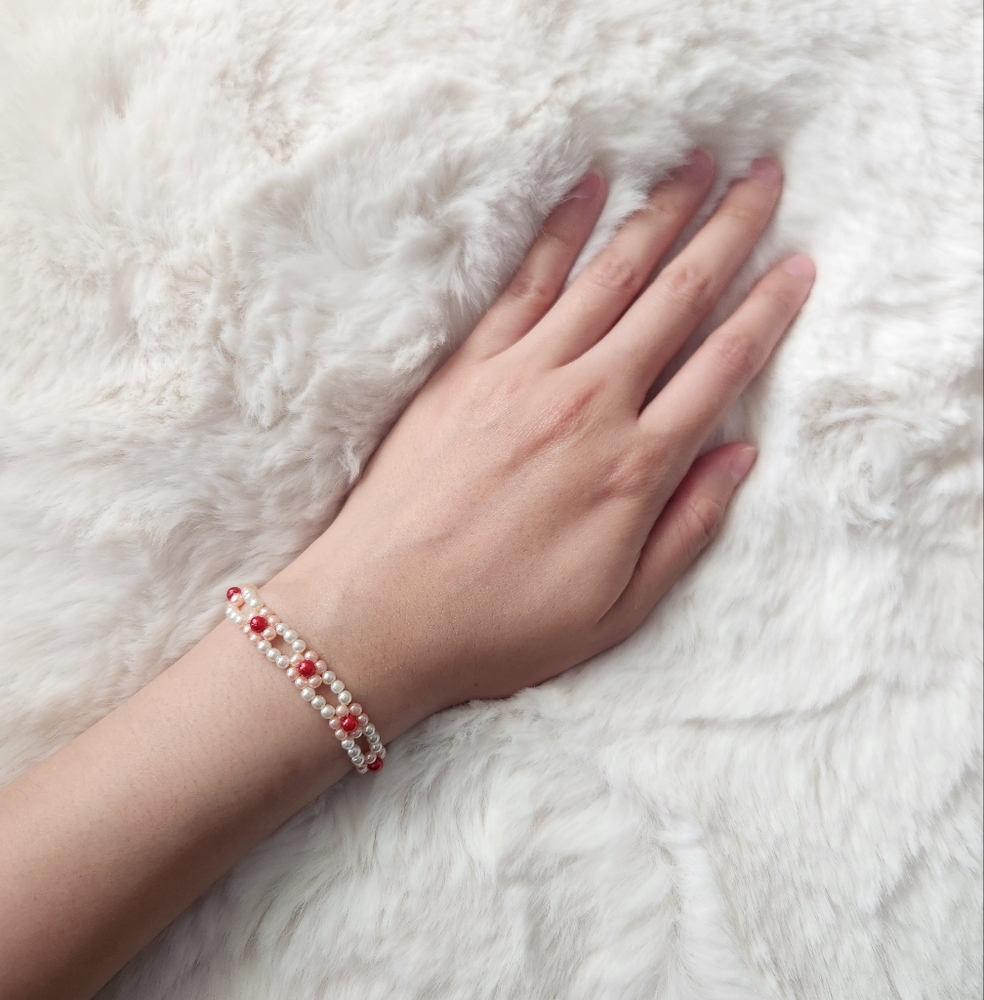 Handmade red pink and cream off white beaded bracelet